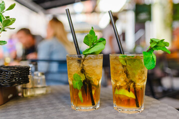 Alcohol drink. On Table cafe outdoors. glasses with alcohol drink and half lime,mint leaves....