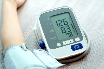 Man check blood pressure monitor and heart rate monitor with digital pressure gauge. Health care...