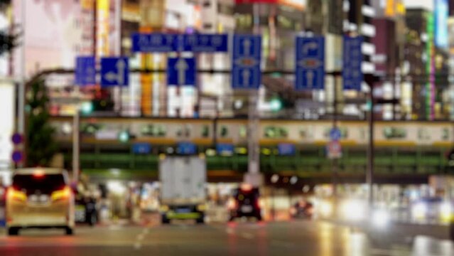 Dramatic city of trains and cars go through between high buildings at night, Shinjuku in Tokyo, Blurred, Business or finance