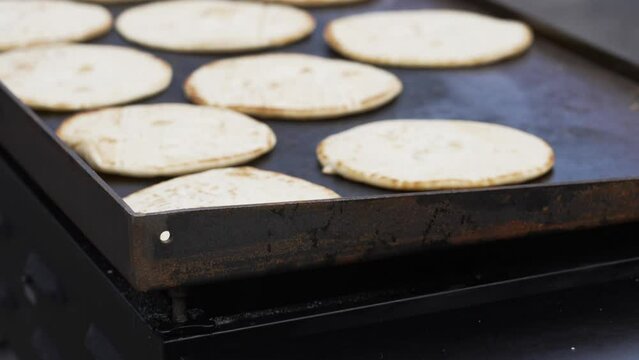 Grilling a large amount of Greek Pita Breads.