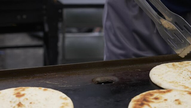 Slow motion in Close Up. Fluffy pita bread on the grill.