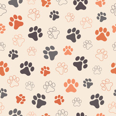 Fototapeta premium Paw animal print silhouettes. Seamless pattern with paws