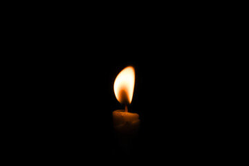 candle flame close up on dark background Melted wax candles that burn at night white candle burning in the dark candlelight	
