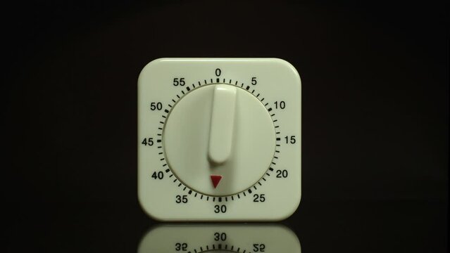 Time lapse of a kitchen clock timer countdown to zero.