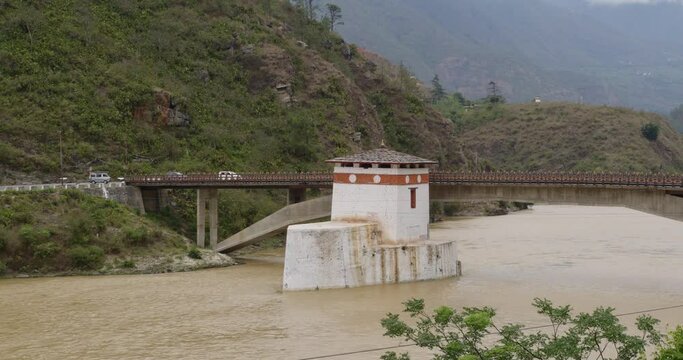 A bridge over a river with a building in it