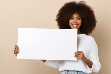 Happy young black woman holding blank white banner sign, isolated studio portrait.