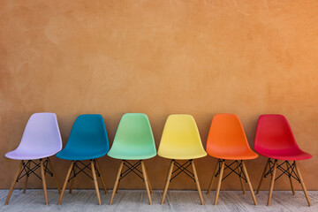 Rainbow colored chairs in a row