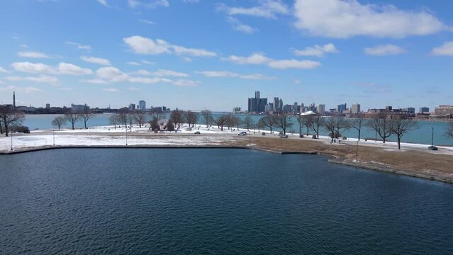 Park of Belle isle with majestic skyline view of Detroit, aerial fly forward view