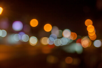 bokeh background of the shop lamps and street  light in the night out of focus