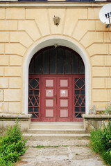 Fototapeta na wymiar vintage door on the ancient facade. typical european architectural element