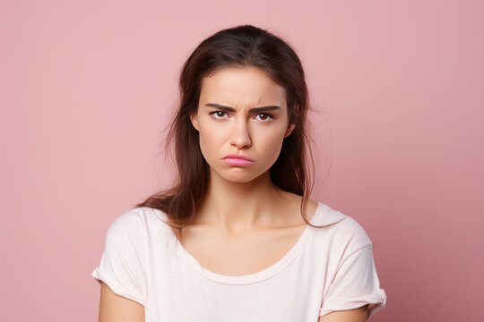 photograph of Photo of unhappy young woman bad mood irritated problem raise eyebrow isolated on pink color background