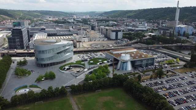4K Cinematic clip of the urban area and the industrial park of Mercedes Benz museum, headquarters, test track and Untert&uuml;rkheim plant in Stuttgart