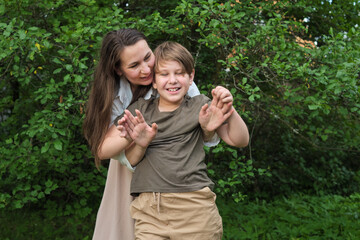 Mother and son sharing an unposed, heartwarming moment in a park, exemplifying the appeal of candid photography