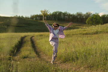 Senior woman, at ease in nature with wildflowers, showcasing the tranquility achievable with secure financial planning