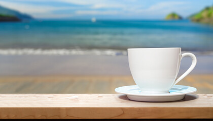 White coffee cup on shelf with blurred sea beach background