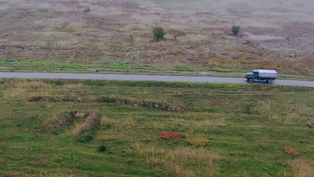 Military car Truck moving on the road. Ukraine Bakhmut Aerial shot