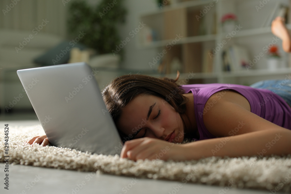 Wall mural Woman sleeping over laptop on the floor