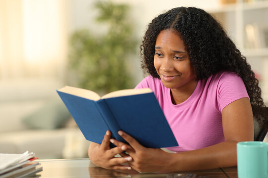 Sensitive black book reader reading at home