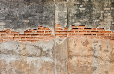 The old cement wall, the cement chipped until the inside bricks were visible.