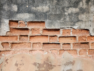 The old cement wall, the cement chipped until the inside bricks were visible.