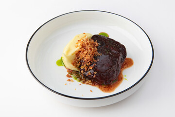 Beef cheeks with mashed potatoes. Meat menu in restaurant. Hearty food.Meat food. Photo on white background for menu.
