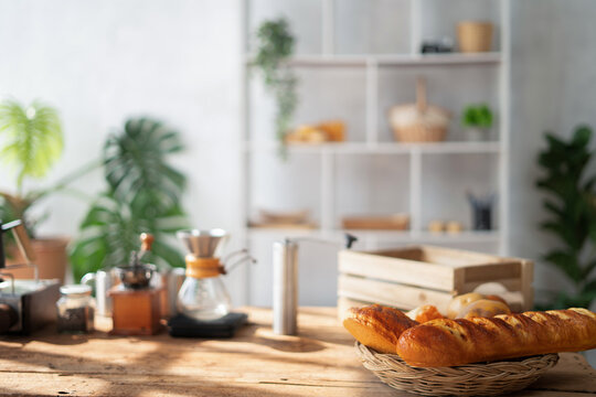 background image of warm-toned kitchen interior with minimal design and wooden table in foreground, copy space