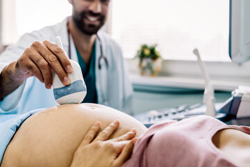 Cropped shot of a pregnant woman during ultrasound scanning at the hospital, clinic. - obrazy, fototapety, plakaty