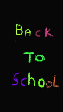 Colorful handwritten text "Back to school" animated in a loop on black background and vertical format