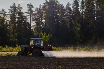 Application of chemical fertilizers to crops by spraying, which is carried out by an agricultural...