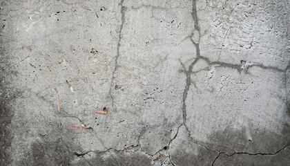 cracked concrete wall covered with gray cement surface as background