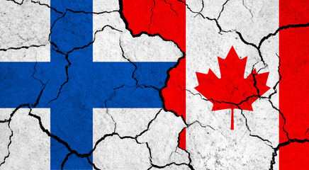 Flags of Finland and Canada on cracked surface - politics, relationship concept