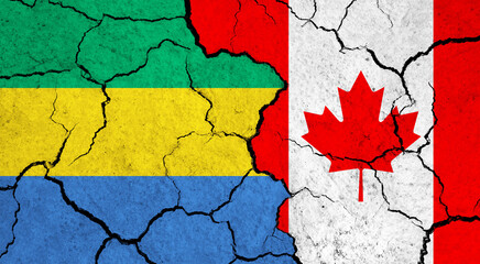Flags of Gabon and Canada on cracked surface - politics, relationship concept