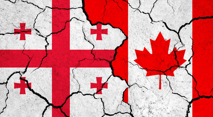Flags of Georgia and Canada on cracked surface - politics, relationship concept
