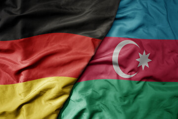 big waving realistic national colorful flag of germany and national flag of azerbaijan .