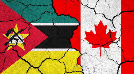 Flags of Mozambique and Canada on cracked surface - politics, relationship concept
