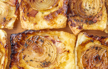 Open pies from puff pastry with cheese, bacon, onion. Mini pizza. Selective focus