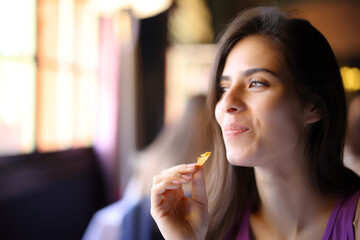 Happy restaurant customer eating chips