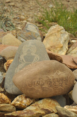 Buddhist mantra and stupa engraved over stone