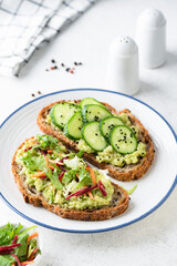 Vegan avocado toast with cucumber and raw carrot beet salad topping