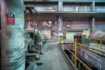 mechanical engines and control panel in an abandoned factory