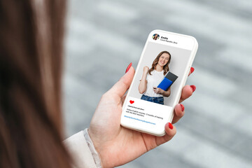 Woman looking at beautiful model's photo on mobile phone. education concept