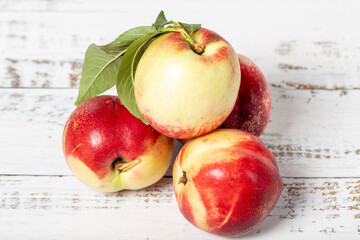 Nectarine on a white wood background. Fresh nectarine harvest season concept. Healthy and fresh fruit. Close up