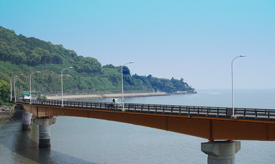 A road bridge across the sea that runs along the coast