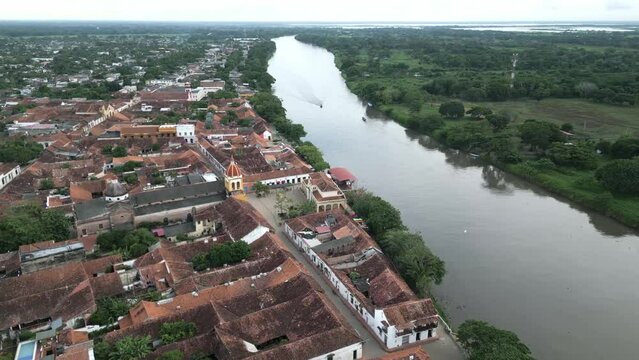 aerial of Santa Cruz de mompox Colombia colonial style little town village in Bolivar department drone above city center with church and river Magdalena