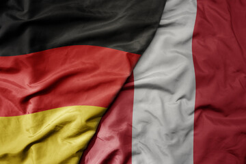 big waving realistic national colorful flag of germany and national flag of peru .