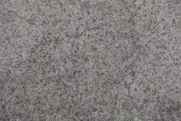 Top view of old cracked and dusty gray concrete slab