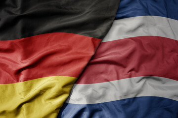 big waving realistic national colorful flag of germany and national flag of costa rica .