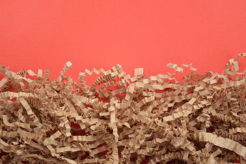 The craft shredded paper on red background.