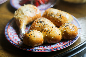Assorted savory pies with sesame seeds