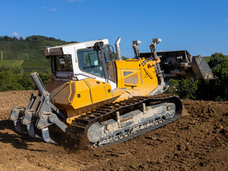 yellow bulldozer doing landfill works